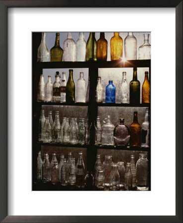 Rows Of Old Bottles In A Flea Market Window Highlighted By The Sun by Stephen St. John Pricing Limited Edition Print image