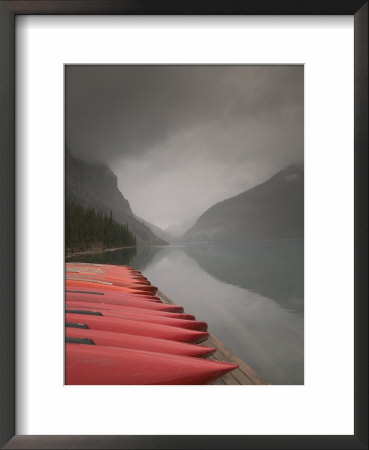 Red Canoes On Lake Louise, Banff National Park, Alberta, Canada by Walter Bibikow Pricing Limited Edition Print image
