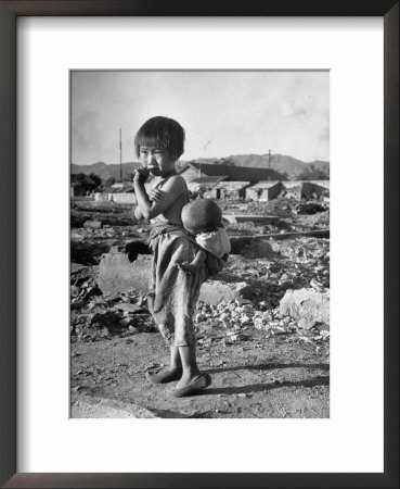 Girl Standing In Rubble From The Korean Civil War, Carrying A Baby In A Sling On Her Back by Joe Scherschel Pricing Limited Edition Print image