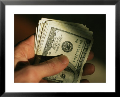 Hand Holds A Wad Of American Hundred Dollar Bills by Stephen Alvarez Pricing Limited Edition Print image