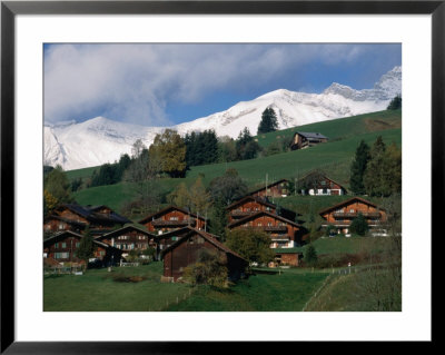 Wooden Chalets On Slope With Snow-Capped Peaks In The Background, Rougemont, Switzerland by Martin Moos Pricing Limited Edition Print image