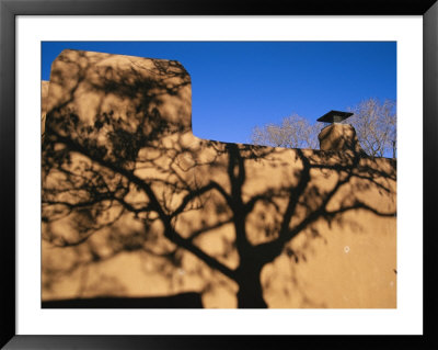 Shadows Of Branches Highlight An Adobe Wall In Old Santa Fe by Stephen St. John Pricing Limited Edition Print image