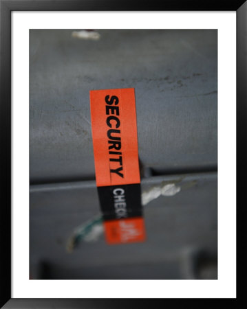 A Security Sticker Is Shown On A Piece Of Baggage by Stephen Alvarez Pricing Limited Edition Print image
