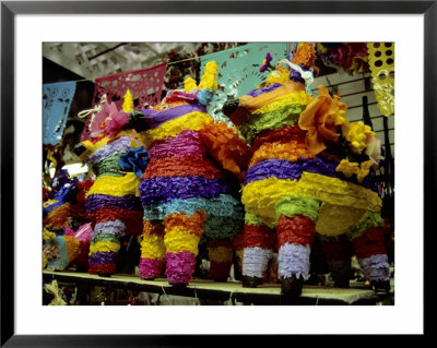 Several Brightly-Colored Pinatas Await Buyers In A Mexican Market by Stephen St. John Pricing Limited Edition Print image