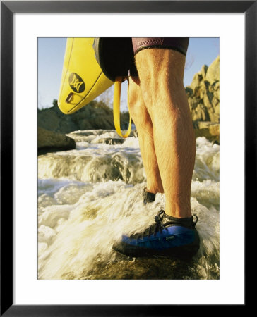 Kayaker With Strong Legs Carrries Kayak Up Rocky Stream Bed by Skip Brown Pricing Limited Edition Print image
