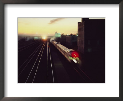 A Trans-Canada Railway Train Rushes Down The Tracks At Dusk by Paul Chesley Pricing Limited Edition Print image