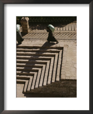 A Man Carrying A Sack Walks Past Stone Steps by Stephen St. John Pricing Limited Edition Print image