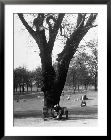 Couple Embracing In A Passionate Moment On The Bench In Hyde Park by Cornell Capa Pricing Limited Edition Print image