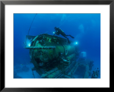 A Diver Swims Around The Submerged Research Station, Aquarius by Brian J. Skerry Pricing Limited Edition Print image