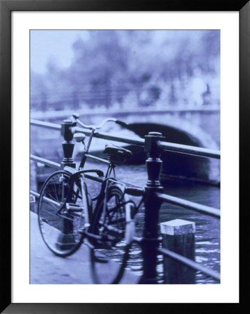 Bicycle On Rail By Canal, Amsterdam, Netherlands by Walter Bibikow Pricing Limited Edition Print image