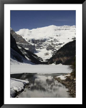 Lake Louise Is Just Beginning To Thaw In The Spring by Stephen Alvarez Pricing Limited Edition Print image