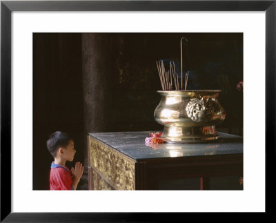 Boy Praying At Kek Lok Si Temple, Penang, Kuala Lumpur, Malaysia, Asia by Charcrit Boonsom Pricing Limited Edition Print image