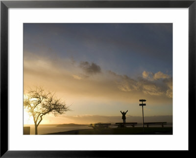 Silhouette Of Girl Stretching At Sunset, Seattle, Washington. United States Of America by Aaron Mccoy Pricing Limited Edition Print image