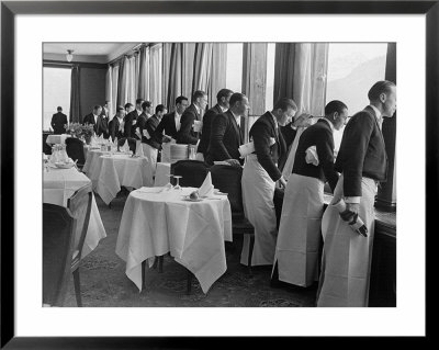 Waiters In The Grand Hotel Dining Room Lined Up At Window Watching Sonja Henie Ice Skating Outside by Alfred Eisenstaedt Pricing Limited Edition Print image