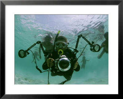 Photographer With Camera Underwater With Diving Moken Tribesmen by Nicolas Reynard Pricing Limited Edition Print image
