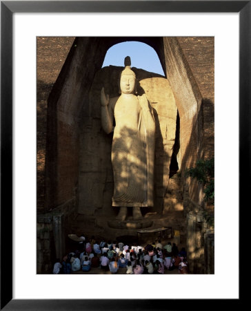 Pilgrims Seated In Front Of The 39 Ft High Standing Buddha, Aukana, Sri Lanka by Upperhall Pricing Limited Edition Print image