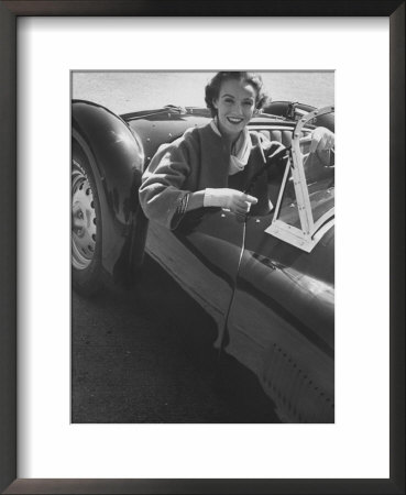 Well Dressed Woman Behind The Wheel Of A Foreign Made Roadster by Nina Leen Pricing Limited Edition Print image