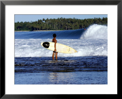 Young Local Boy On Reef Heading Out For Afternoon Surf, Lagundri Bay, Indonesia by Paul Kennedy Pricing Limited Edition Print image