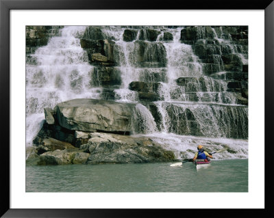 A Woman Paddles Her Kayak Next To A Waterfall by Bill Hatcher Pricing Limited Edition Print image