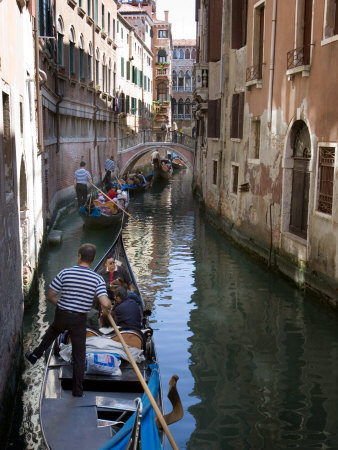 Gondoliers Escort Tourists Through Canals Of San Marco, Venice, Italy by Robert Eighmie Pricing Limited Edition Print image