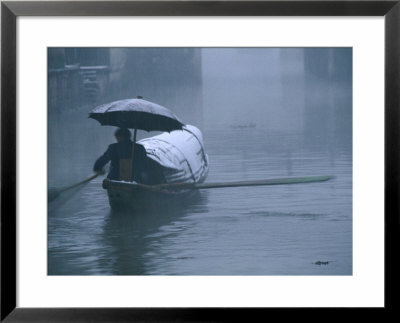 Man Rowing His Bamboo Boat In A Snow Storm, Shaoxing, China by Keren Su Pricing Limited Edition Print image