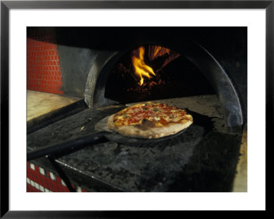 Pizza Comes Out Of A Brick Oven In A Restaurant In Rome, Italy by Richard Nowitz Pricing Limited Edition Print image