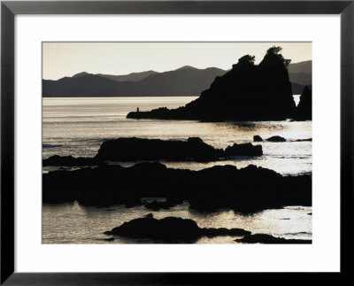 Lone Fisherman On Rocks At Sunrise In Russell, Bay Of Islands, Northland, New Zealand by Stephen Saks Pricing Limited Edition Print image