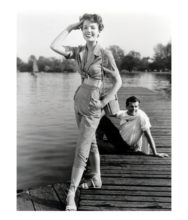 Pat Goddard In Malcom Brown Gingham Blouse And Jeans With Roger Moore, 1952 by John French Pricing Limited Edition Print image