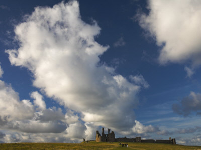 Clouds Over Dunstanburgh Castle, Northumberland, England by Adam Burton Pricing Limited Edition Print image