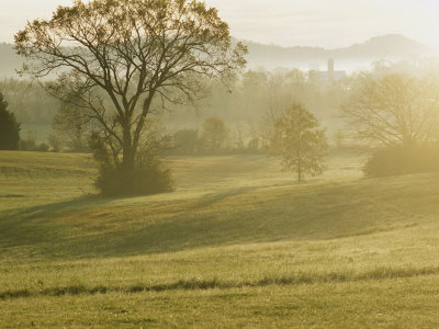 Early Morning Mist Hangs Over A Farm In Tennessee by Stephen Alvarez Pricing Limited Edition Print image