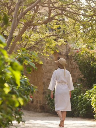 Woman Walks Along A Garden Path by Taylor S. Kennedy Pricing Limited Edition Print image