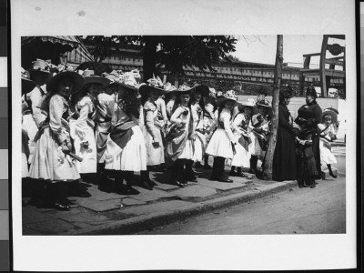 A Group Of Girls Dressed In White Dresses With Sashes And Flower-Covered Hats For Children's Day by Wallace G. Levison Pricing Limited Edition Print image