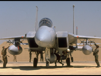 Us Crewmen Checking An F-15 Fighter's Sidewinder Missiles At An Airfield by Dennis Brack Pricing Limited Edition Print image