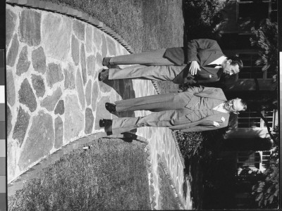 Writer Damon Runyon Walking And Talking With Unidentified Man by Gjon Mili Pricing Limited Edition Print image