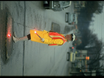 Policewoman In Yellow Slicker Monitoring Traffic On Dixie Highway by Ralph Crane Pricing Limited Edition Print image