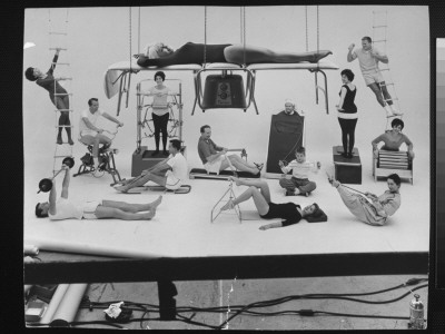 People Posing On Various Types Of Home Exercise Equipment by Yale Joel Pricing Limited Edition Print image