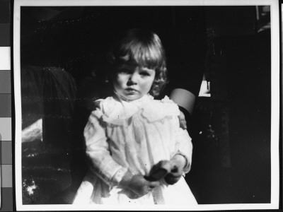 A Sweet Little Girl Holding A Hairbrush by George B. Brainerd Pricing Limited Edition Print image