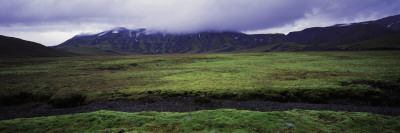 Mossy Landscape, Mountains In Background And Very Cloudy Sky, Iceland by Bjarki Reyr Asmundsson Pricing Limited Edition Print image