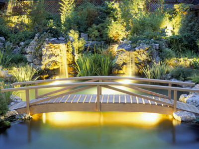Wooden Bridge Over Koi Pond, Lighting By Garden And Security Lighting by Clive Nichols Pricing Limited Edition Print image