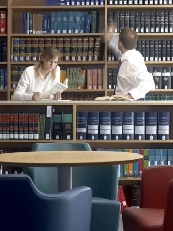 Office Life And Interiors Part Two, Employees In Library Reading And Referencing Information by Richard Bryant Pricing Limited Edition Print image