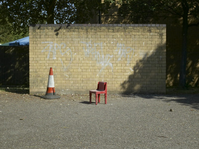 Housing, Kingston-Upon-Thames, Surrey, Brick Wall With Small Red Chair And Traffic Cone by Tim Mitchell Pricing Limited Edition Print image