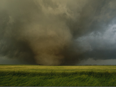 An F4 Category Tornado Travels Across A Field At Great Speed by Carsten Peter Pricing Limited Edition Print image