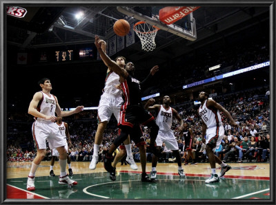 Miami Heat V Milwaukee Bucks: Andrew Bogut And Dwyane Wade by Jonathan Daniel Pricing Limited Edition Print image