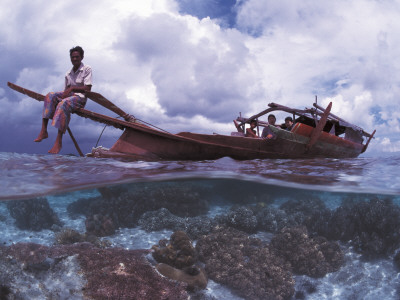 Bajau Fisherman On Lepa Boat In Shallow Water Over Coral Reef, Pulau Gaya, Borneo, Malaysia by Jurgen Freund Pricing Limited Edition Print image