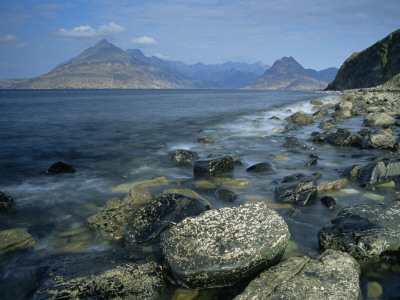 Rugged Coast Of Skye, Scotland, With The Cuillin Hills Across The Bay by Adam Burton Pricing Limited Edition Print image