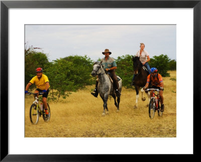 Mountain Bikers And Horse Riders At Mashatu Game Reserve, Botswana by Roger De La Harpe Pricing Limited Edition Print image