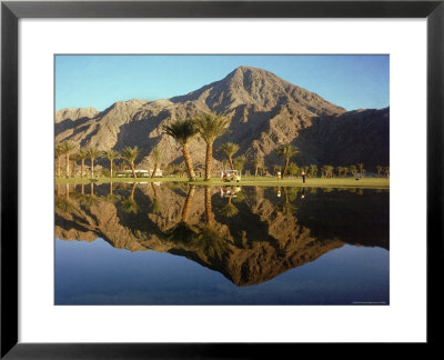 Golfers Framed By The Santa Rosa Mountains While Playing A Round At The Eldorado Country Club by Ralph Crane Pricing Limited Edition Print image
