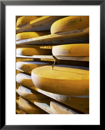 Comte Cheeses With Cheese Tester In Fort De Rousse Cheese Cellar by Joerg Lehmann Pricing Limited Edition Print image