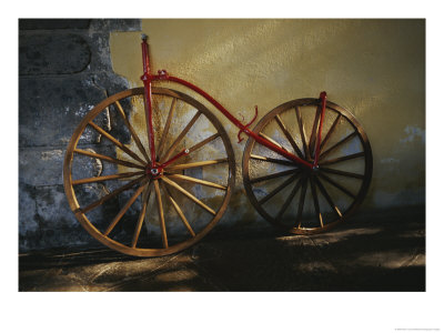 An Antique Bicycle Rests Against A Wall by Raul Touzon Pricing Limited Edition Print image