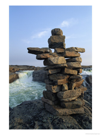 A Carefully Balanced Cairn Overlooking The Kerchoffer River by Norbert Rosing Pricing Limited Edition Print image